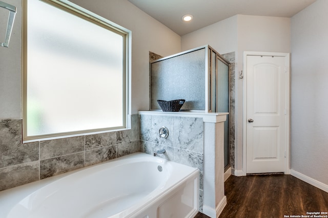 bathroom with wood-type flooring and separate shower and tub