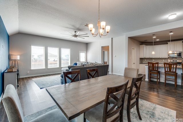 dining room with a textured ceiling, ceiling fan with notable chandelier, and dark hardwood / wood-style flooring