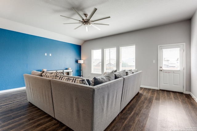 living room featuring lofted ceiling, ceiling fan, and dark wood-type flooring