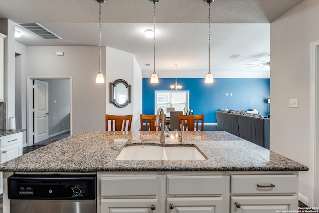 kitchen with white cabinets, sink, and stone countertops