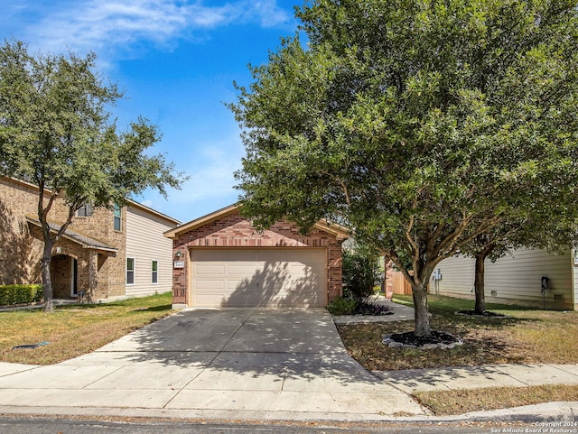 ranch-style house with a garage and a front lawn