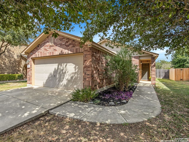 ranch-style house featuring a front yard and a garage