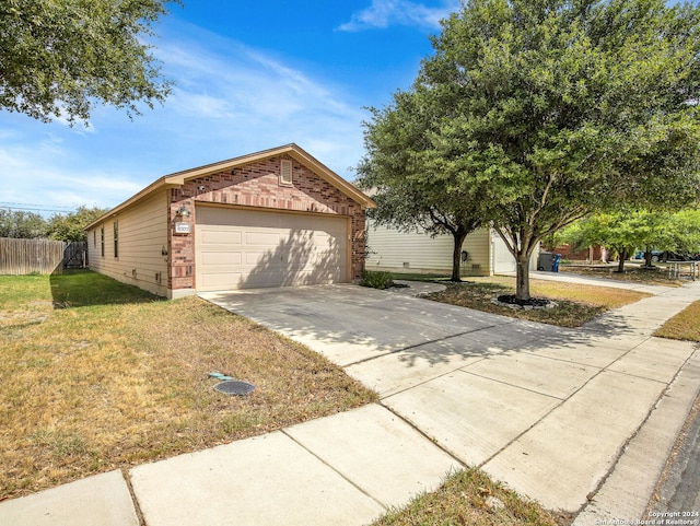 view of front of property with a front yard and a garage