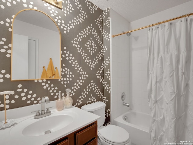 full bathroom with shower / bath combo with shower curtain, a textured ceiling, vanity, and toilet