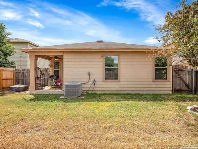 back of house with ceiling fan, a yard, a patio, and central AC unit