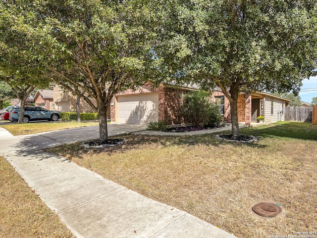 obstructed view of property featuring a front lawn and a garage