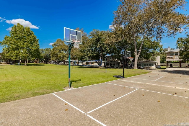 view of sport court with a yard