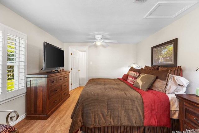 bedroom with ceiling fan and light hardwood / wood-style floors