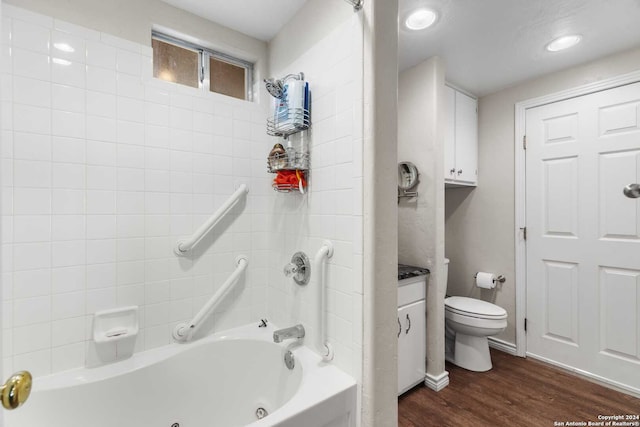 full bathroom featuring vanity, hardwood / wood-style floors, toilet, and shower / bathtub combination