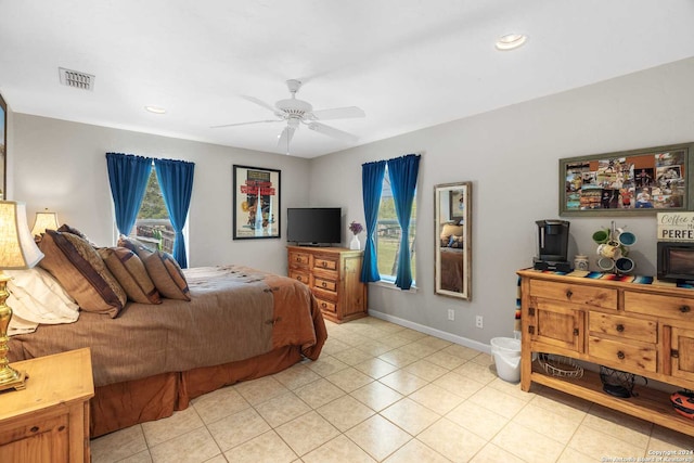 tiled bedroom featuring ceiling fan