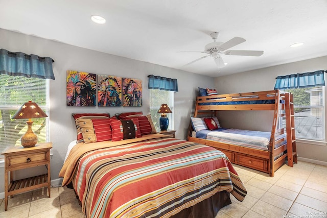 tiled bedroom with multiple windows and ceiling fan