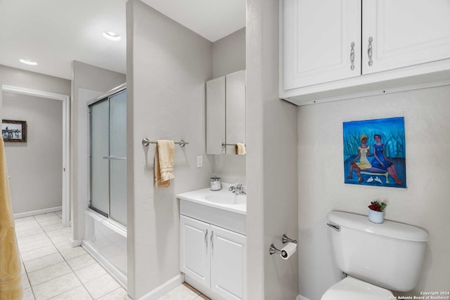 full bathroom featuring enclosed tub / shower combo, vanity, toilet, and tile patterned floors