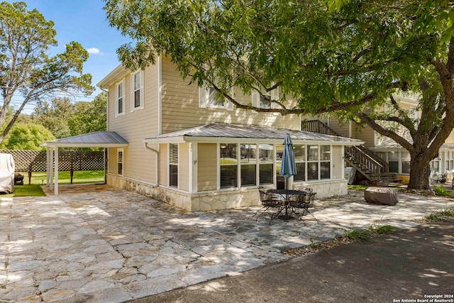 back of house with a patio