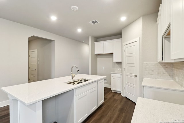 kitchen featuring dark hardwood / wood-style flooring, a kitchen island with sink, sink, and white cabinets