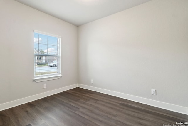 spare room with dark wood-type flooring