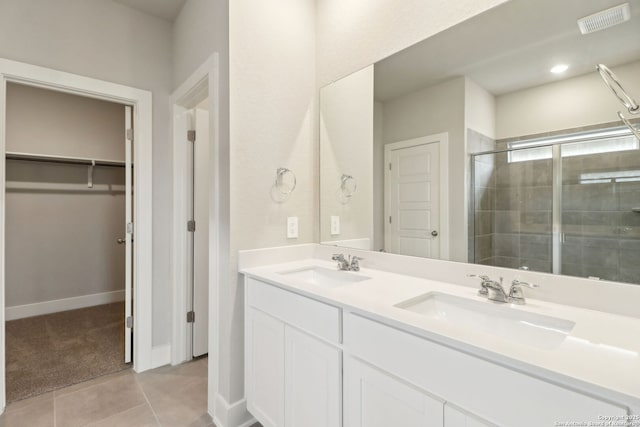 bathroom with tile patterned flooring, vanity, and a shower with shower door