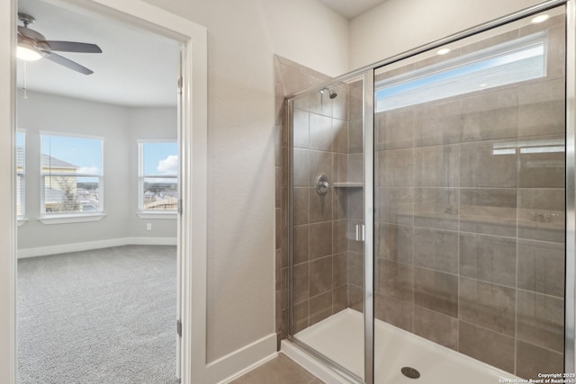 bathroom featuring an enclosed shower and ceiling fan