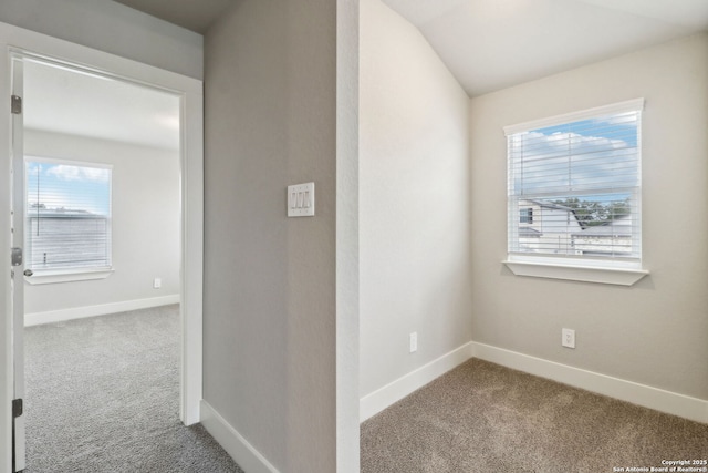 hall with lofted ceiling and carpet flooring