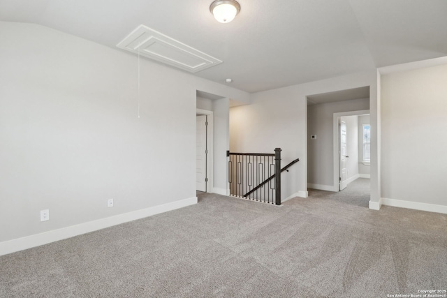 carpeted spare room featuring lofted ceiling