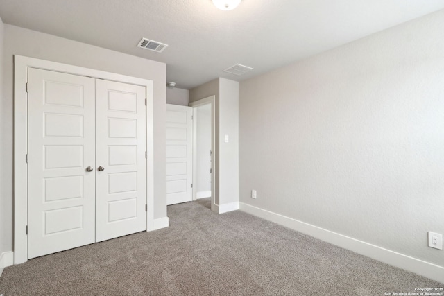 unfurnished bedroom with carpet and a closet