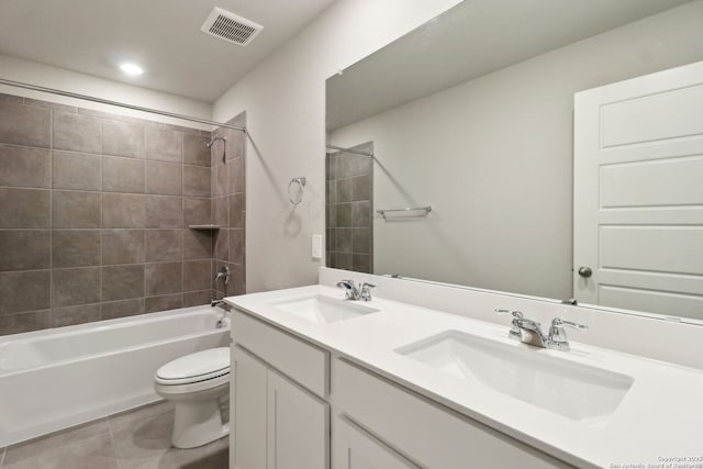 full bathroom with tile patterned floors, toilet, tiled shower / bath combo, and vanity