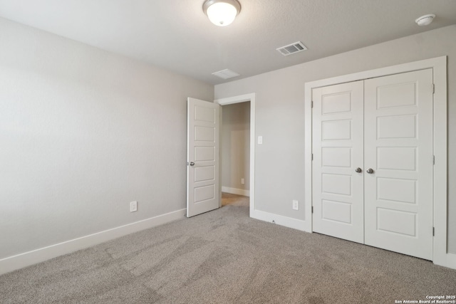 unfurnished bedroom with carpet flooring and a closet