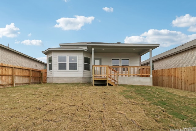 back of house with a lawn