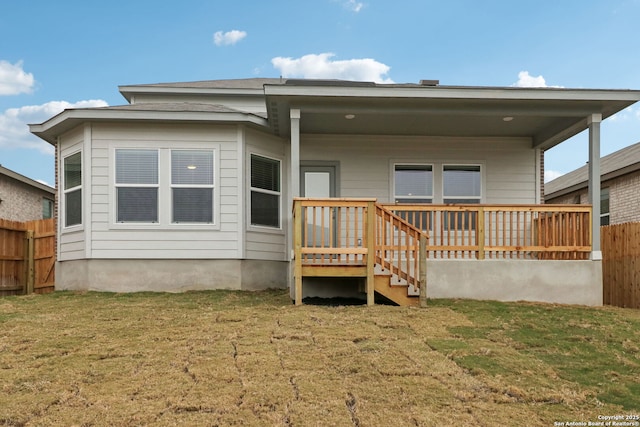 rear view of property with a lawn