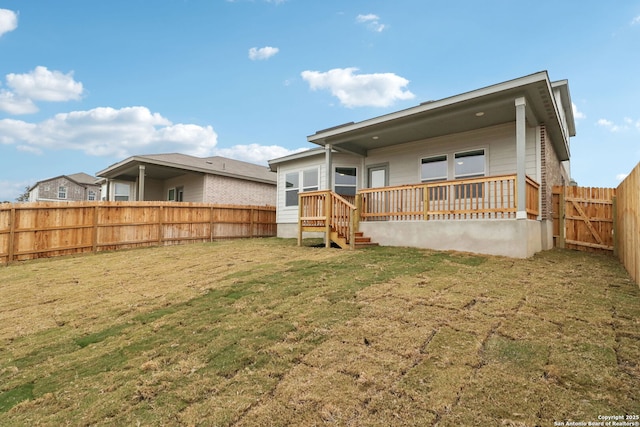 rear view of house featuring a yard