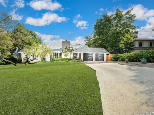 view of front of house featuring a garage and a front lawn