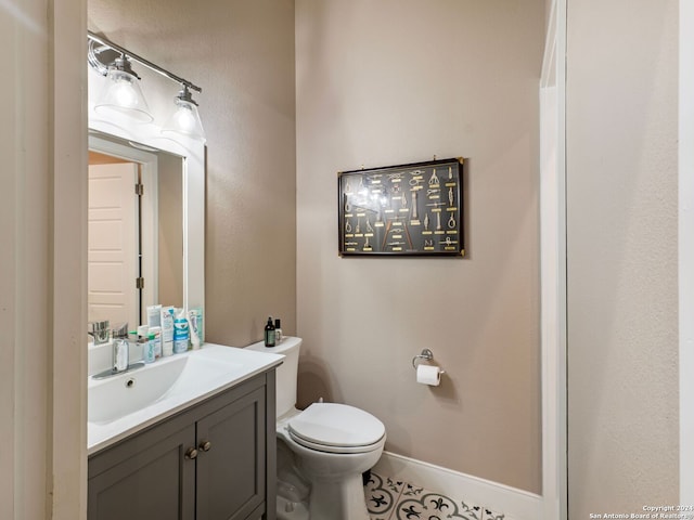 bathroom with tile patterned floors, vanity, and toilet