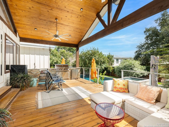 deck with exterior kitchen, area for grilling, ceiling fan, and an outdoor hangout area