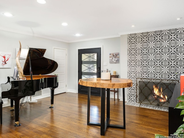 interior space with a fireplace, crown molding, and hardwood / wood-style floors