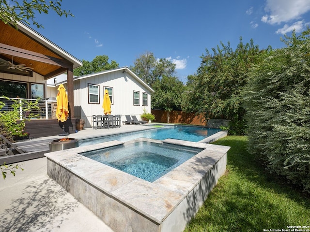 view of pool featuring ceiling fan, a patio, and an in ground hot tub