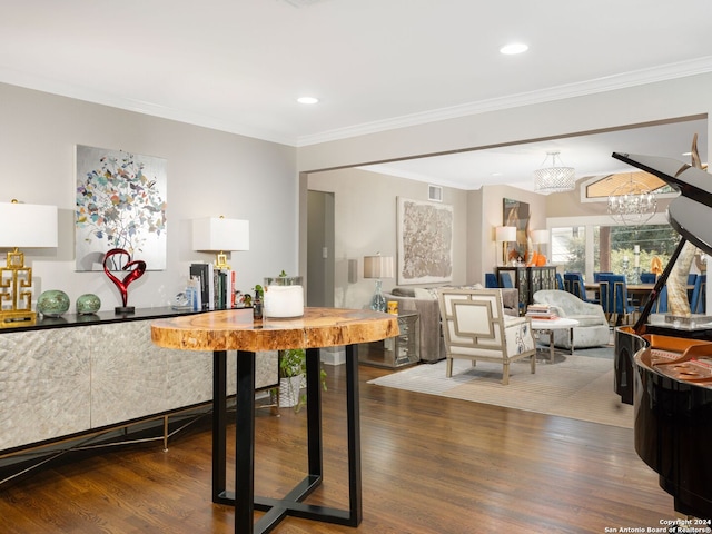 dining space with an inviting chandelier, crown molding, and dark hardwood / wood-style flooring