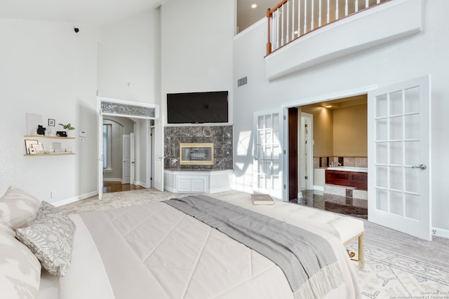 bedroom featuring french doors, high vaulted ceiling, and a fireplace