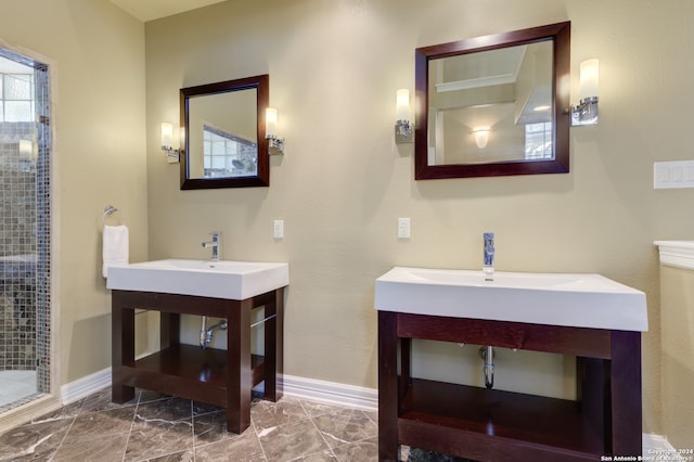 bathroom featuring a tile shower and vanity