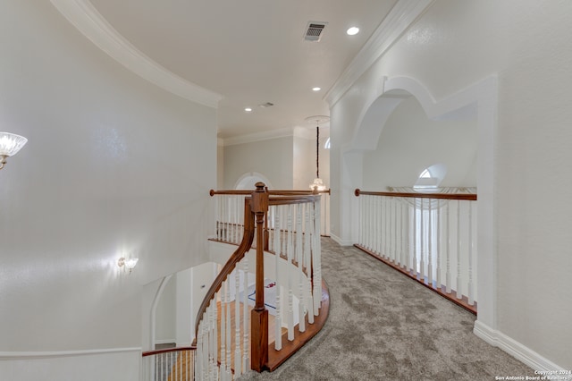 hall with crown molding and carpet