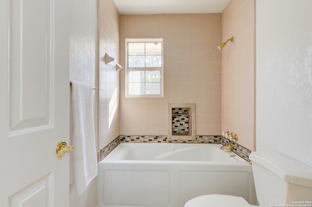 bathroom featuring toilet and a bathing tub