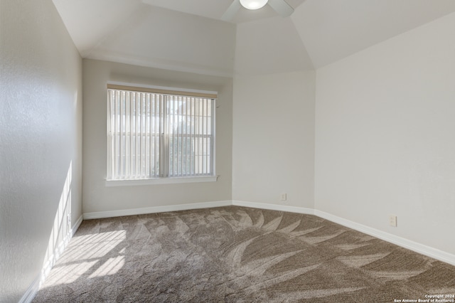 unfurnished room featuring light carpet, vaulted ceiling, and ceiling fan