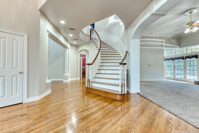 entryway with crown molding, light hardwood / wood-style flooring, french doors, and ceiling fan