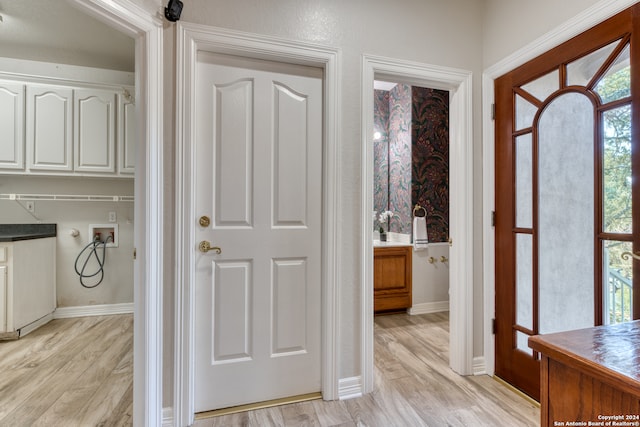 bathroom featuring wood-type flooring and a healthy amount of sunlight