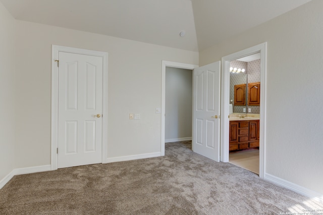 unfurnished bedroom with connected bathroom, sink, and light carpet