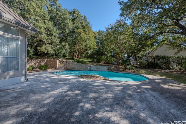 view of swimming pool featuring a patio area