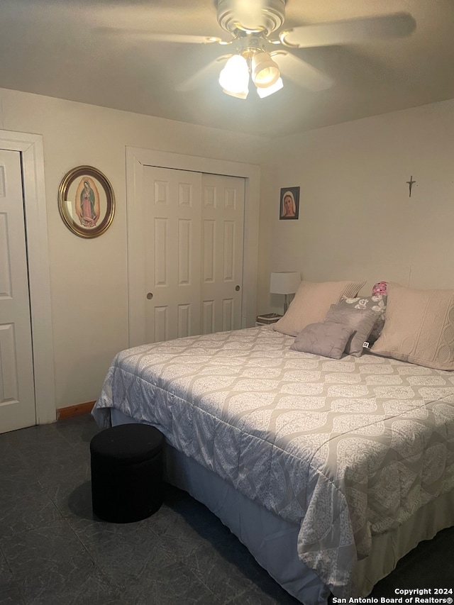 bedroom with ceiling fan and a closet