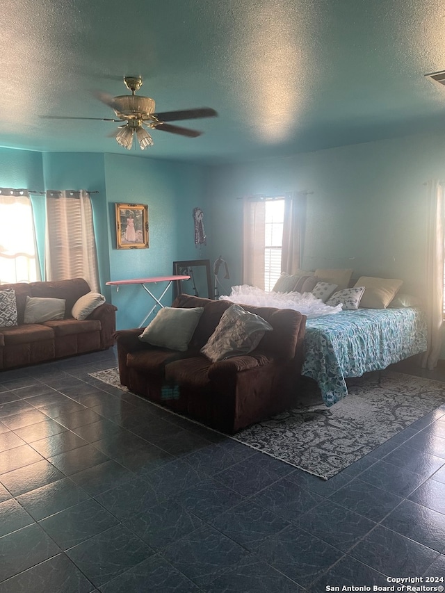 bedroom featuring a textured ceiling and ceiling fan