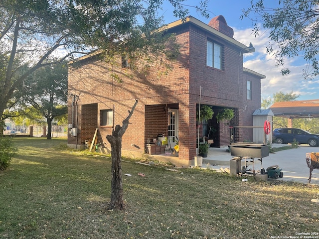 back of house with a patio and a yard