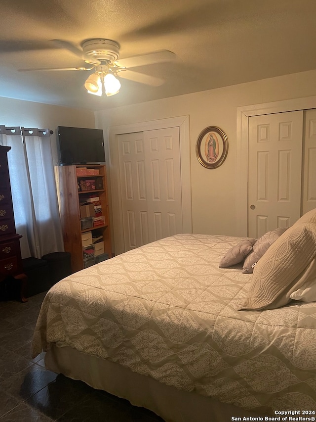 bedroom with two closets and ceiling fan