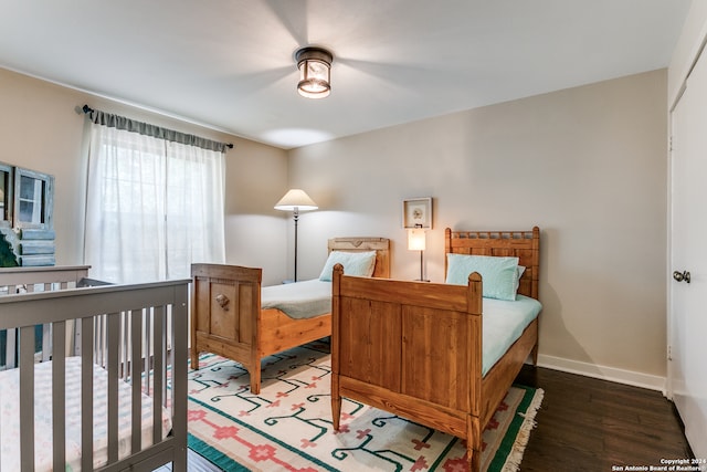 bedroom featuring a closet and dark hardwood / wood-style flooring