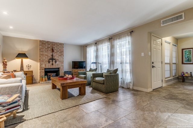 living room with a brick fireplace